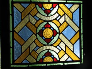 Leadlight stained glass Whangarei. Symmetrical stained glass design with bright yellow and red glass