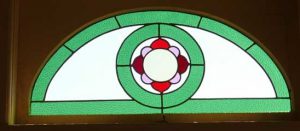 Leadlight stained glass Whangarei. Stained glass arch design with a central floral design