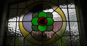 Leadlight stained glass Whangarei. Stained glass rose design with bright coloured green red glass