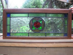 Leadlight stained glass Whangarei. Rectangular leadlight stained glass with a floral center set in a rectangular long frame