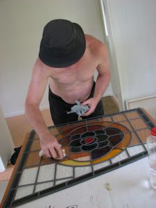 Leadlight stained glass Whangarei. Mishka Patterson at work on leadlight stained glass