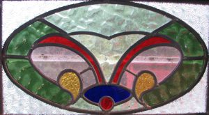 Leadlight stained glass Whangarei. Oval stained glass design. Red green blue yellow and clear glass