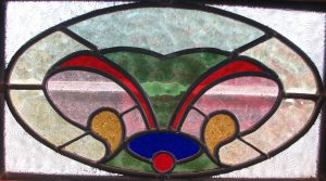 Leadlight stained glass Whangarei. Oval stained glass design. Red green blue yellow and clear glass