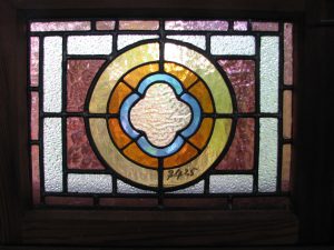 Leadlight stained glass Whangarei. Stained glass symmetrical design. Circular inside rectangular frame